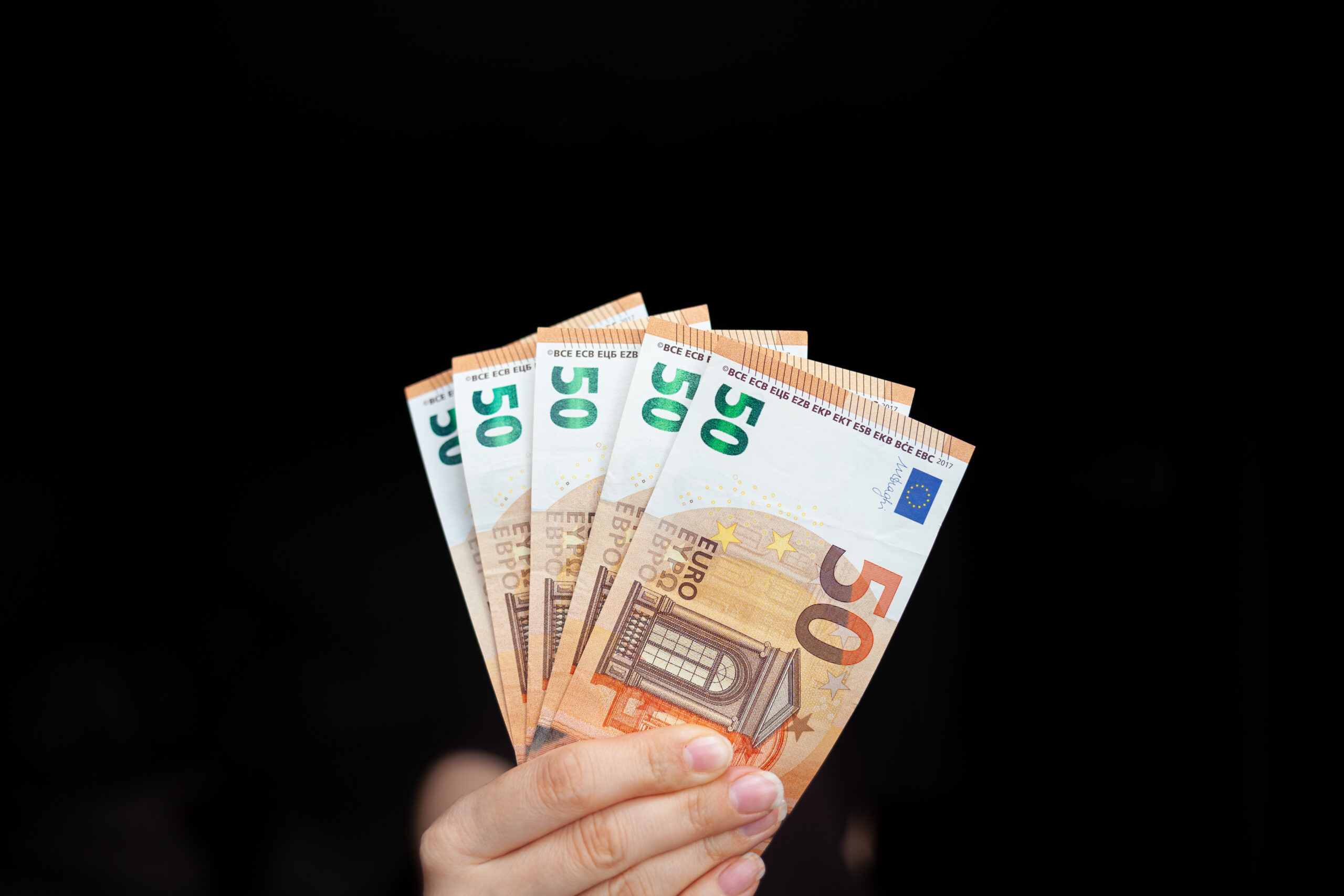 a man holds 50 euro banknotes in his hand on a dar 2025 03 09 20 39 45 utc scaled